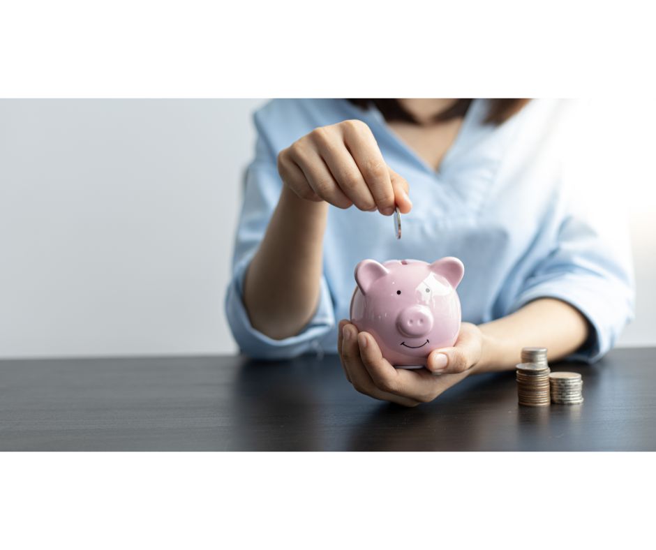 Woman placing coin in piggy bank