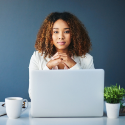a woman holding her other hand whilst at a laptop