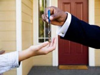 man handing keys to new homeowner