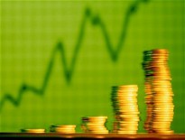 stacks of gold coins against green background