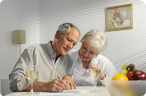 elderly couple looking at documents