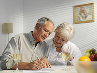 elderly couple looking at documents