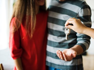 young couple receiving house keys