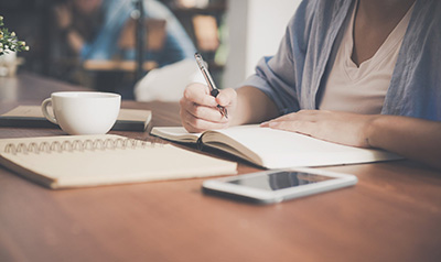 woman writing in a notebook