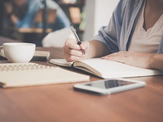 woman writing in a notebook