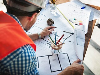 workman looking at property plans