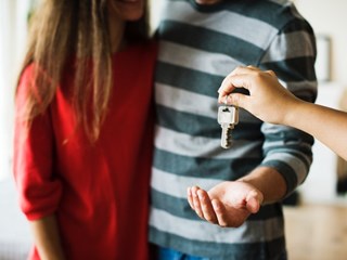 couple getting key to home
