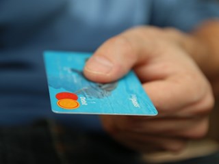 man holding blue bank card