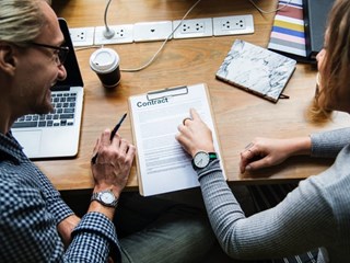 business people looking at a contract document