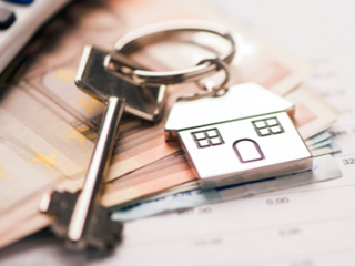 a key with a house key ring