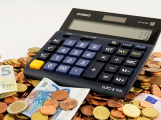 calculator surrounded by money