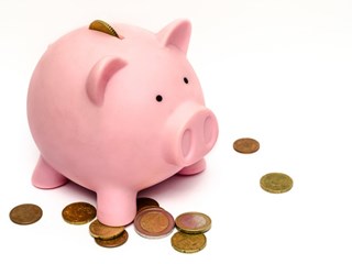 pink piggy bank and coins