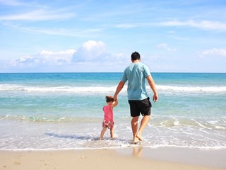 man and child at the beach