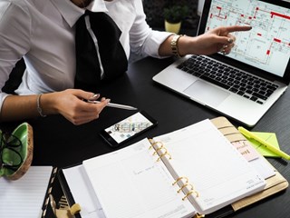 office working pointing at laptop screen