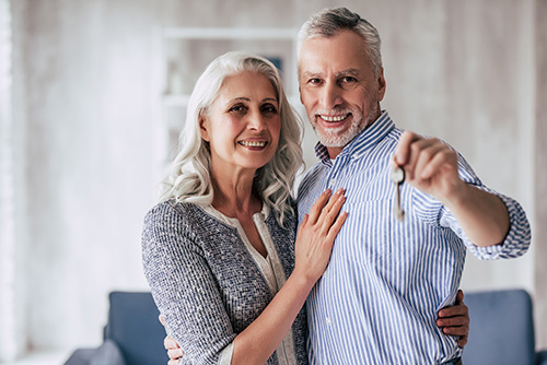 happy couple holding up a key