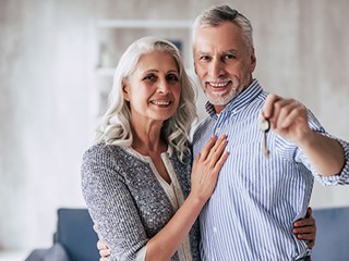 happy couple holding up a key