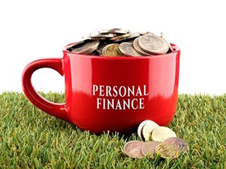 personal finance mug full of coins