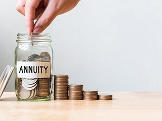 annuity savings jar with stack of coins