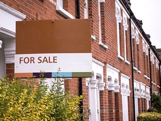 for sale sign outside residential house