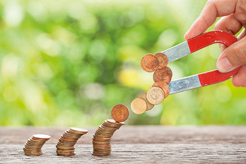 magnet pulling coins from stacks