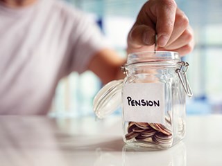 Person depositing a coin in a jar labelled 'pensions'