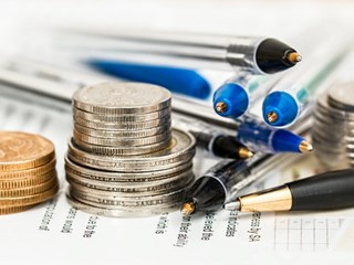 coins and pens on paperwork