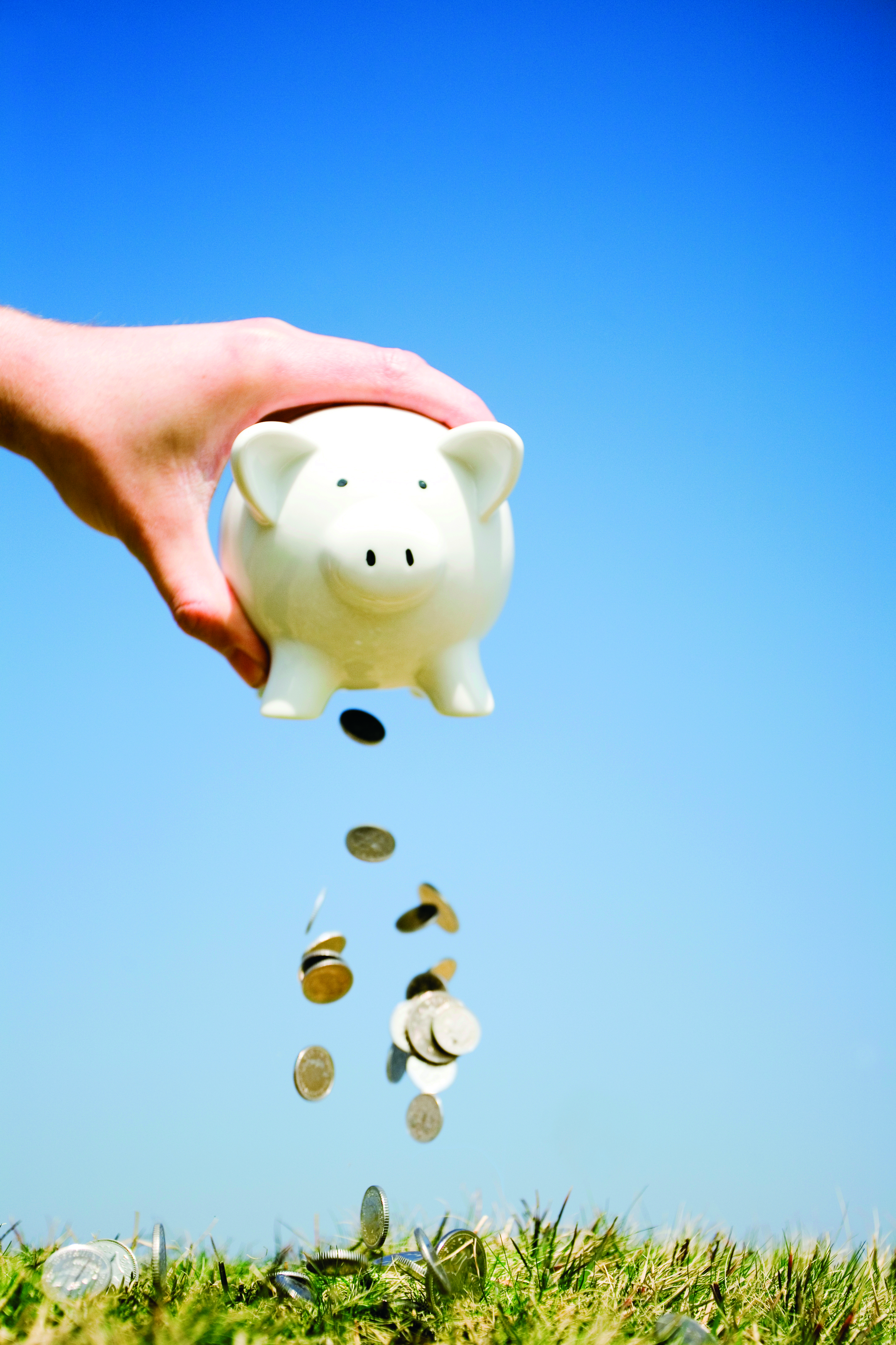 coins falling out of a piggy bank