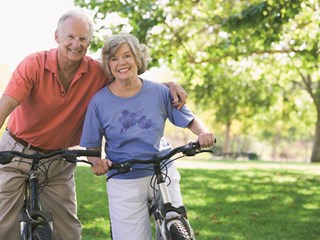 elderly couple on bikes