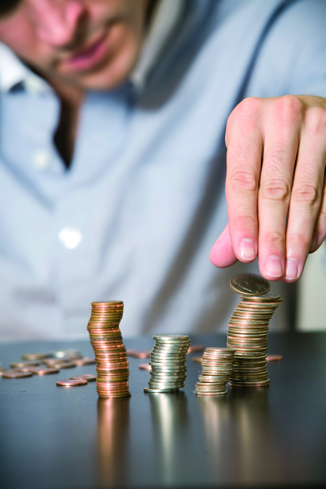 man stacking coins