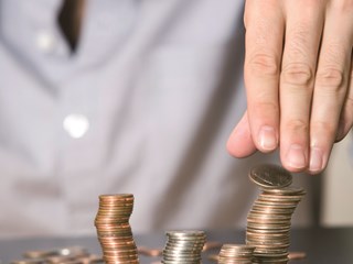 man stacking coins