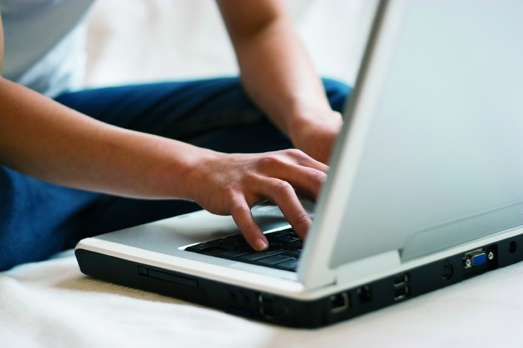 person typing on a laptop