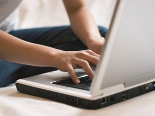 person typing on a laptop