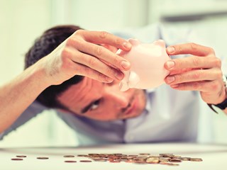 Looking for higher returns on you savings? | Person emptying piggybank