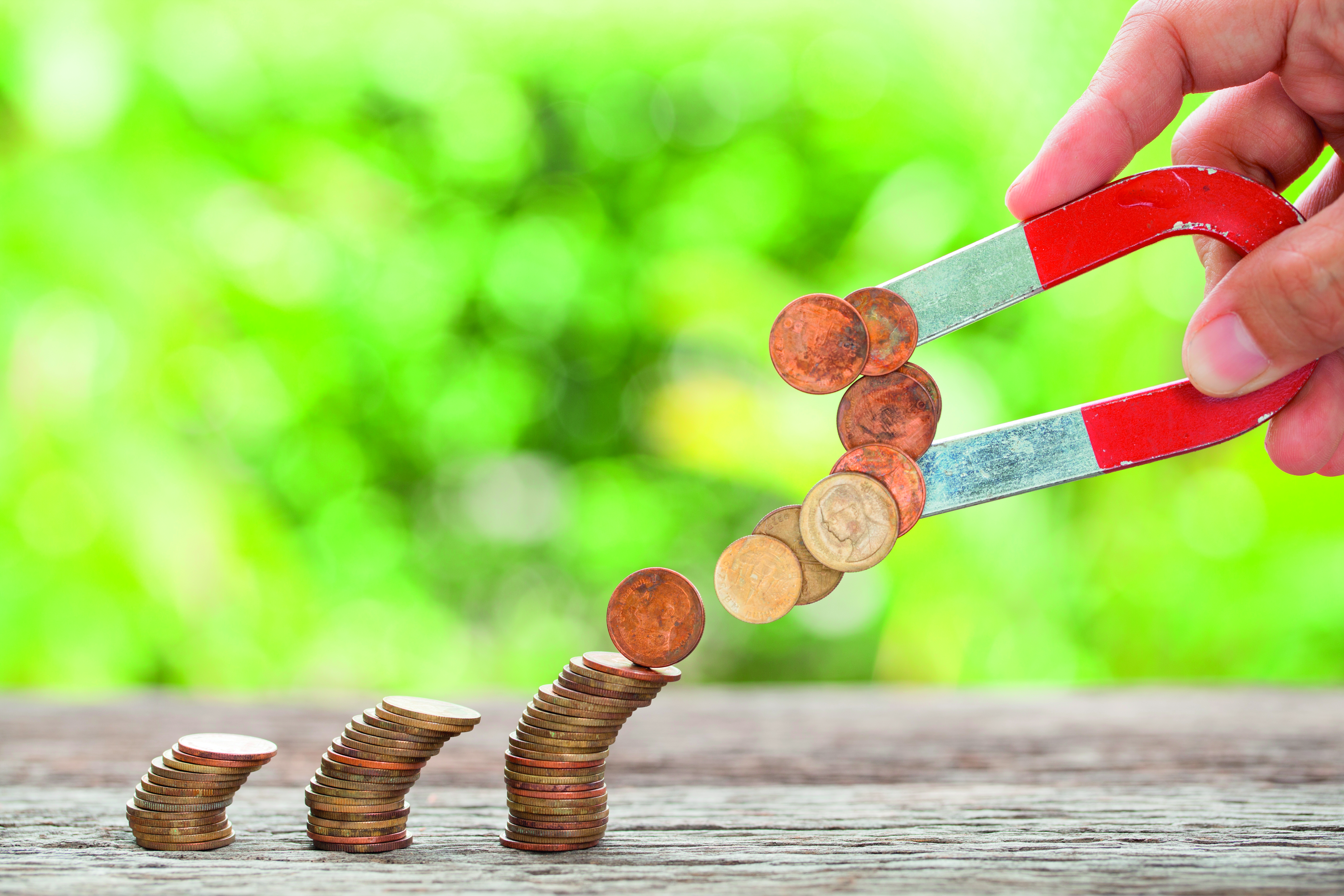 magnet pulling coins off a coin stack