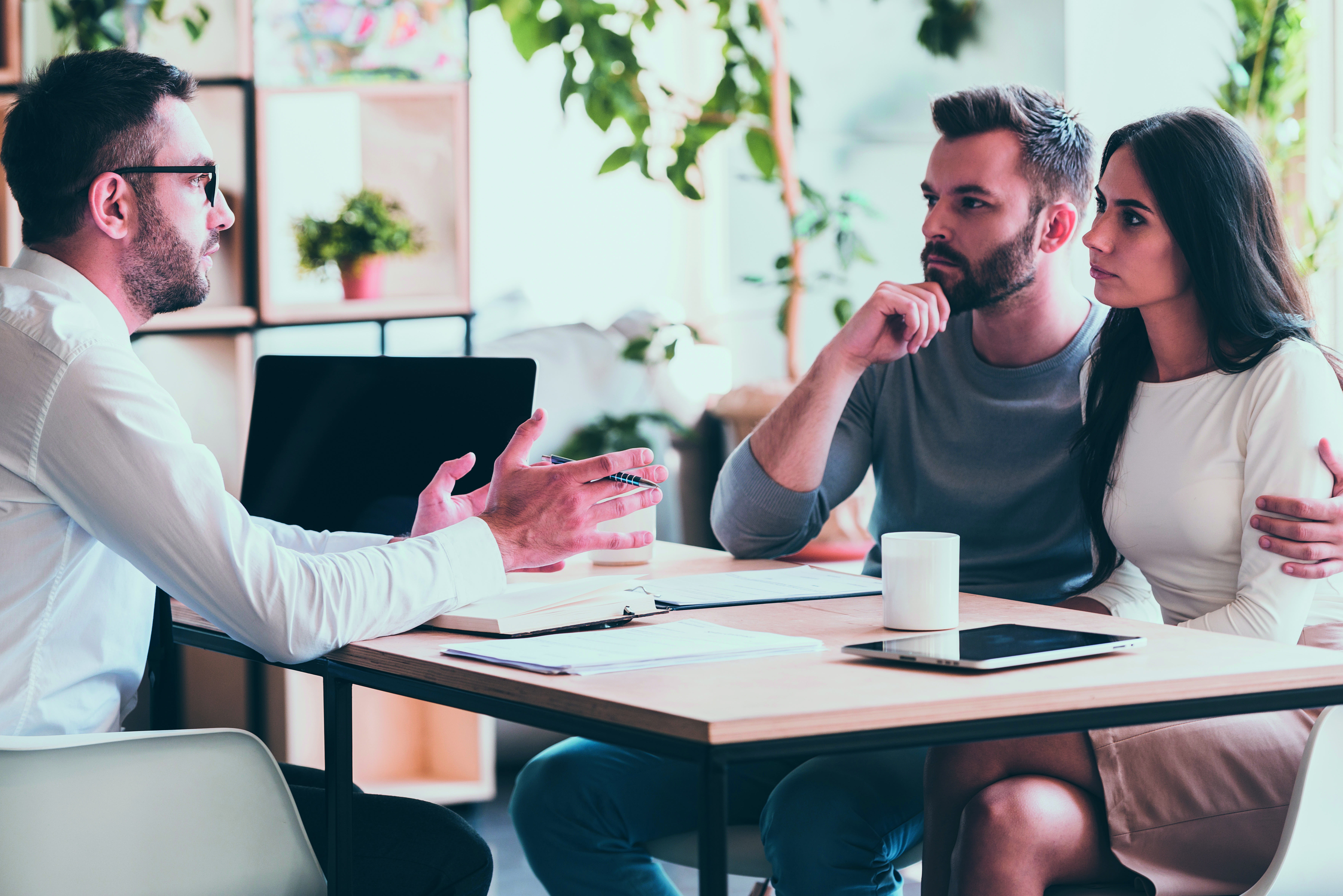 Man and woman listening to man talking