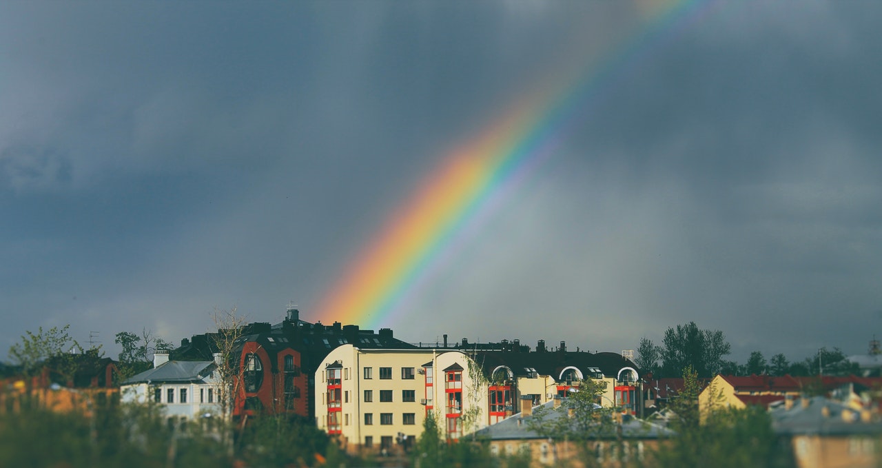 rainbow over houses on rainy day