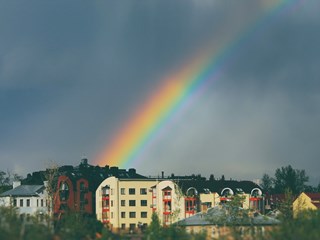 rainbow over houses on rainy day
