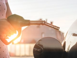 a person holding a petrol pump