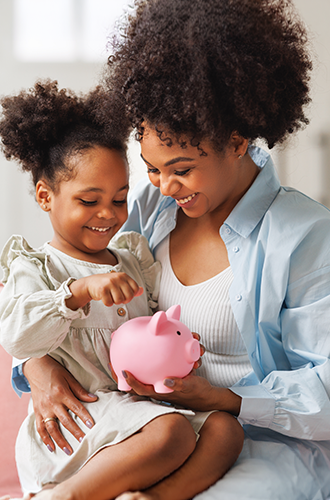 Mother and daughter holding a piggy bank
