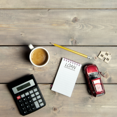 a few objects on top of a table including a calculator and a cup of tea