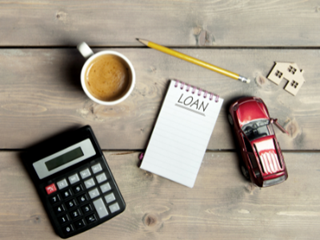 a few objects on top of a table including a calculator and a cup of tea