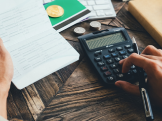 a person working out finances on a calculator