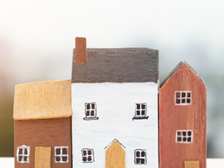 three miniature houses made from clay