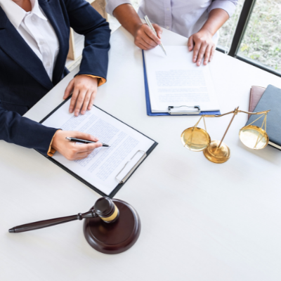 two people completing legal paperwork