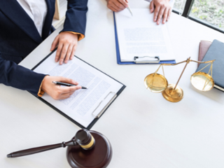 two people completing legal paperwork