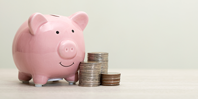 Piggy bank with coin stacks