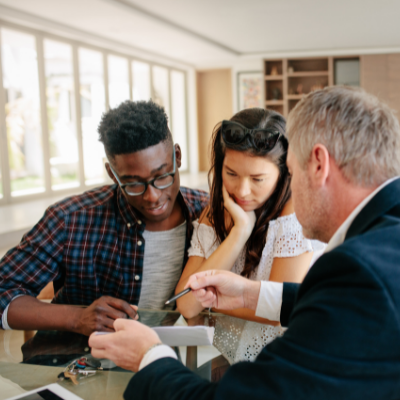 a guarantor explaining loans to a young couple