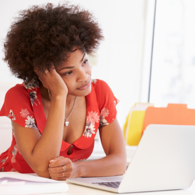 Business woman looking frustrated at her laptop
