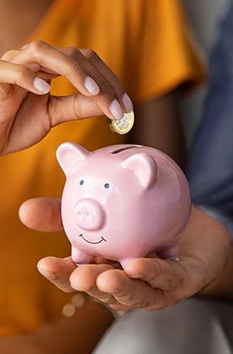 Holding piggy bank plus coin