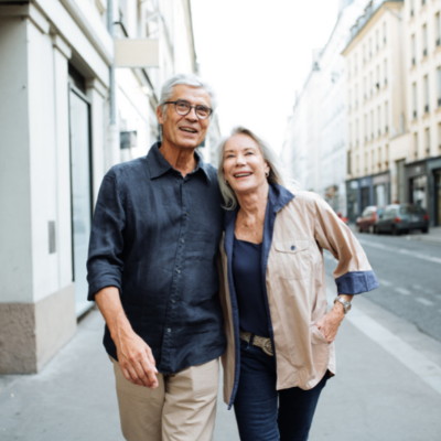 Retired couple walking arm in arm